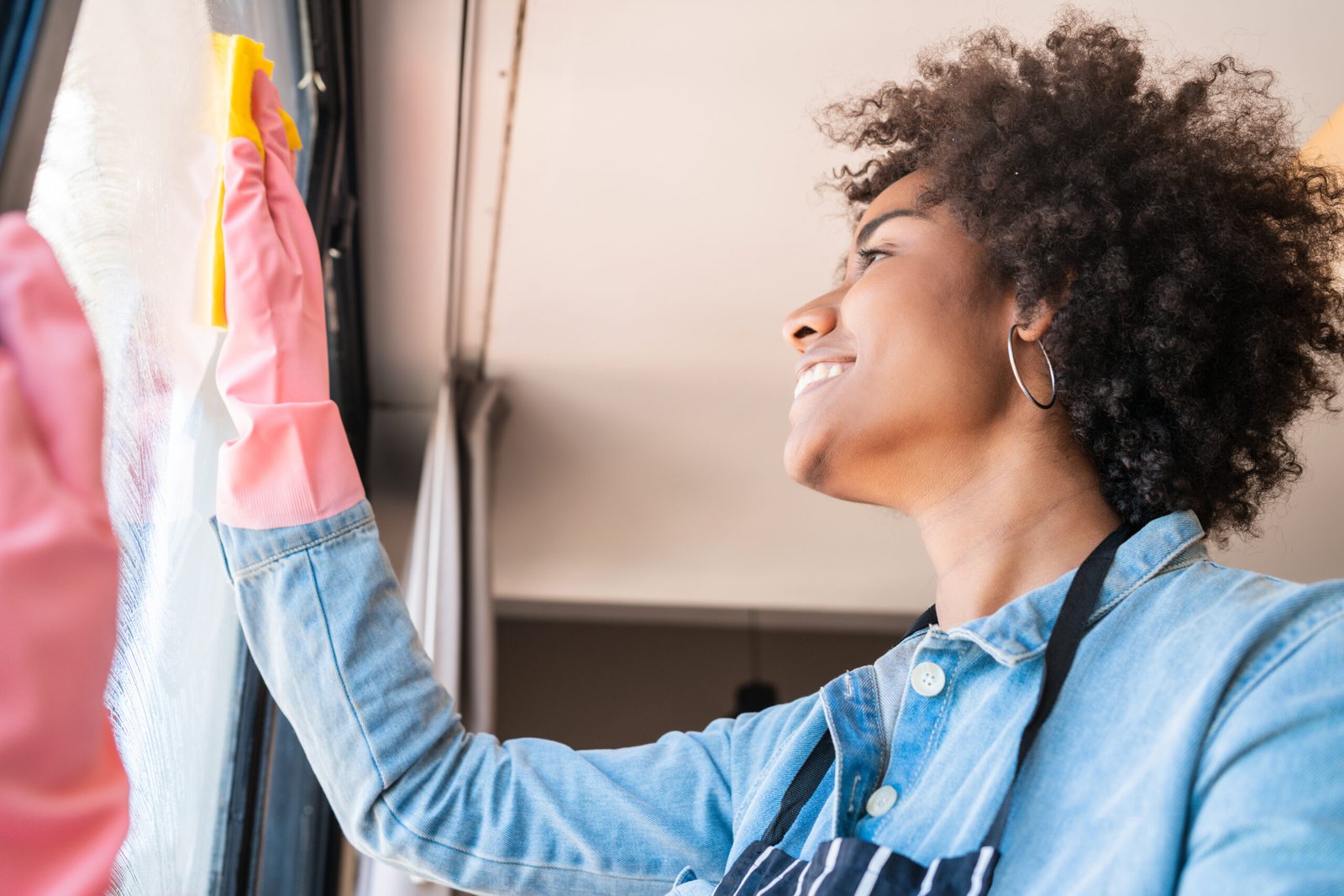 Professional Black cleaning team standing together with cleaning supplies inside bright commercial building in Maryland